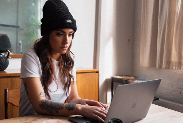 A woman sitting in front of her laptop.